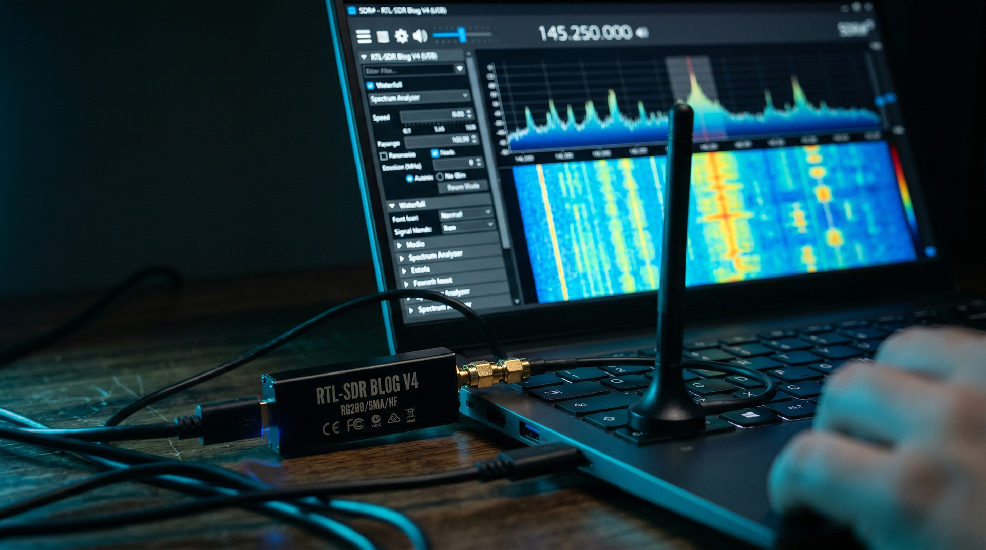 RTL-SDR dongle connected to laptop showing signal spectrum waterfall display — Bytes & PCs Santa Clarita